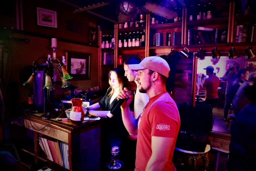 A man sings karaoke in the Espresso Art Cafe bar.